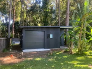Small grey colorbond shed with small window and roller door