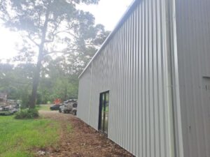 Side view of wide colorbond shed with sliding glass doors