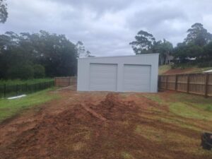 Skillion roof backyard shed with two medium sized roller doors