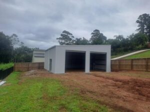 Side view of skillion roof backyard shed with two medium sized roller doors